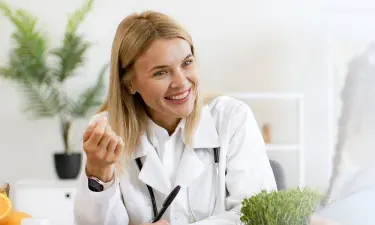 Georgia family nurse practitioner smiling with pediatric patient during appointment